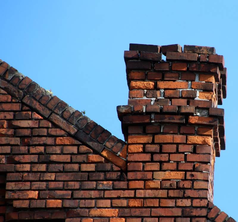 Damaged chimney on an Waterbury home showing cracks and missing mortar